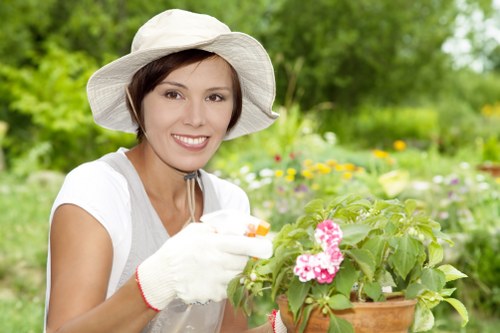 Trained gardener wearing PPE and using tools safely